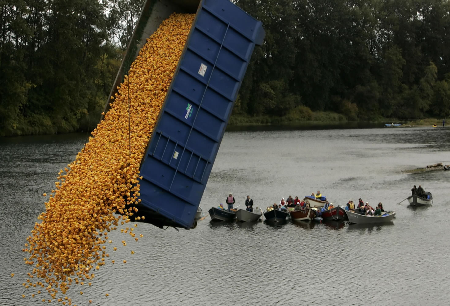 Boaters watch as thousands of rubber ducks are released into the Willamette River in 2007 at the Autzen Footbridge during the annual Rotary Duck Race in Eugene, Ore.