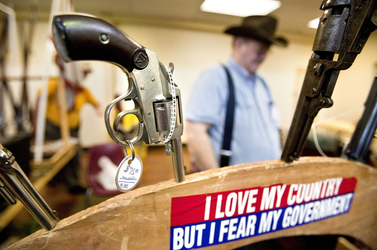 A pistol is displayed for sale by gun collector Steve Frost on Feb. 16, 2013, during the Sports Connection Gun Show in Yakima. Washington voters will decide in November if background checks for gun sales should be expanded, or prohibited from exceeding federal requirements.