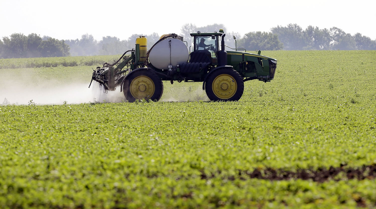 Blake Beckett of West Central Cooperative sprays a soybean field in Granger, Iowa.