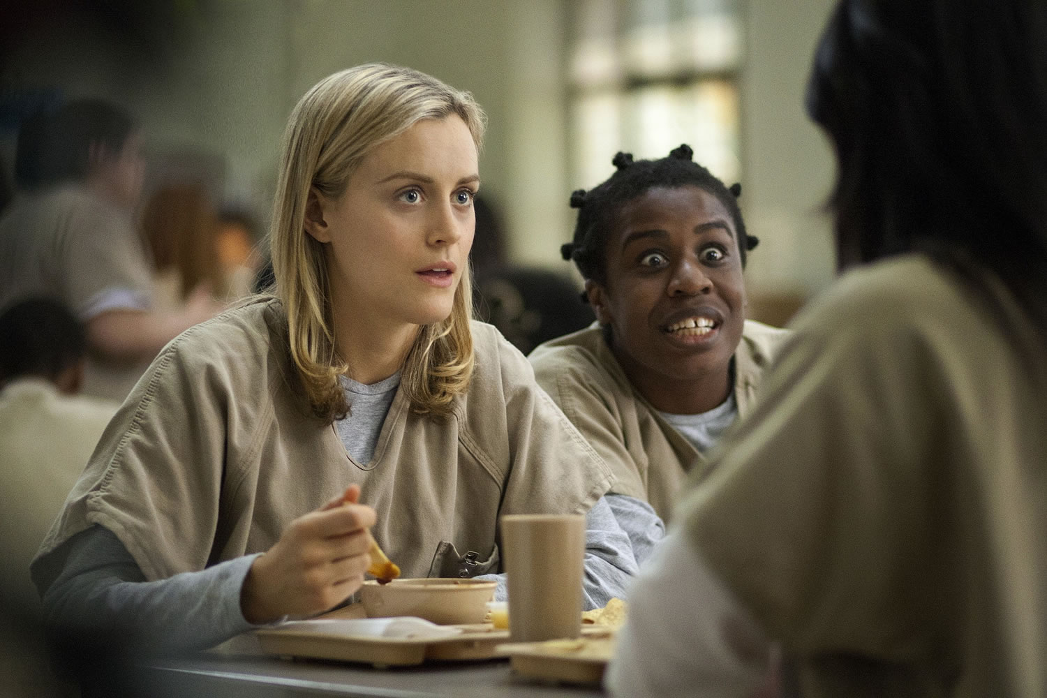 Taylor Schilling, left, and Uzo Aduba in a scene from &quot;Orange Is the New Black.&quot; Netflix reports quarterly earnings on Monday.