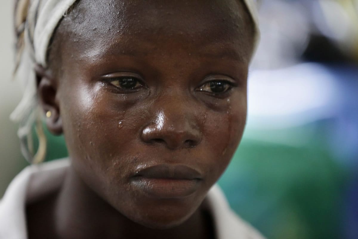 In this photo taken Tuesday, Aug. 11, 2015, Ebola survivor Victoria Yillia cries as she recalls her family members who died of Ebola, at a maternity ward at the Kenema government hospital on the outskirts of Freetown, Sierra Leone. Yillia, who delivered her child just a few minutes&iacute; walk from the ward where just last year she had hovered between life and death, lost all of her relatives when the virus ripped through her community.