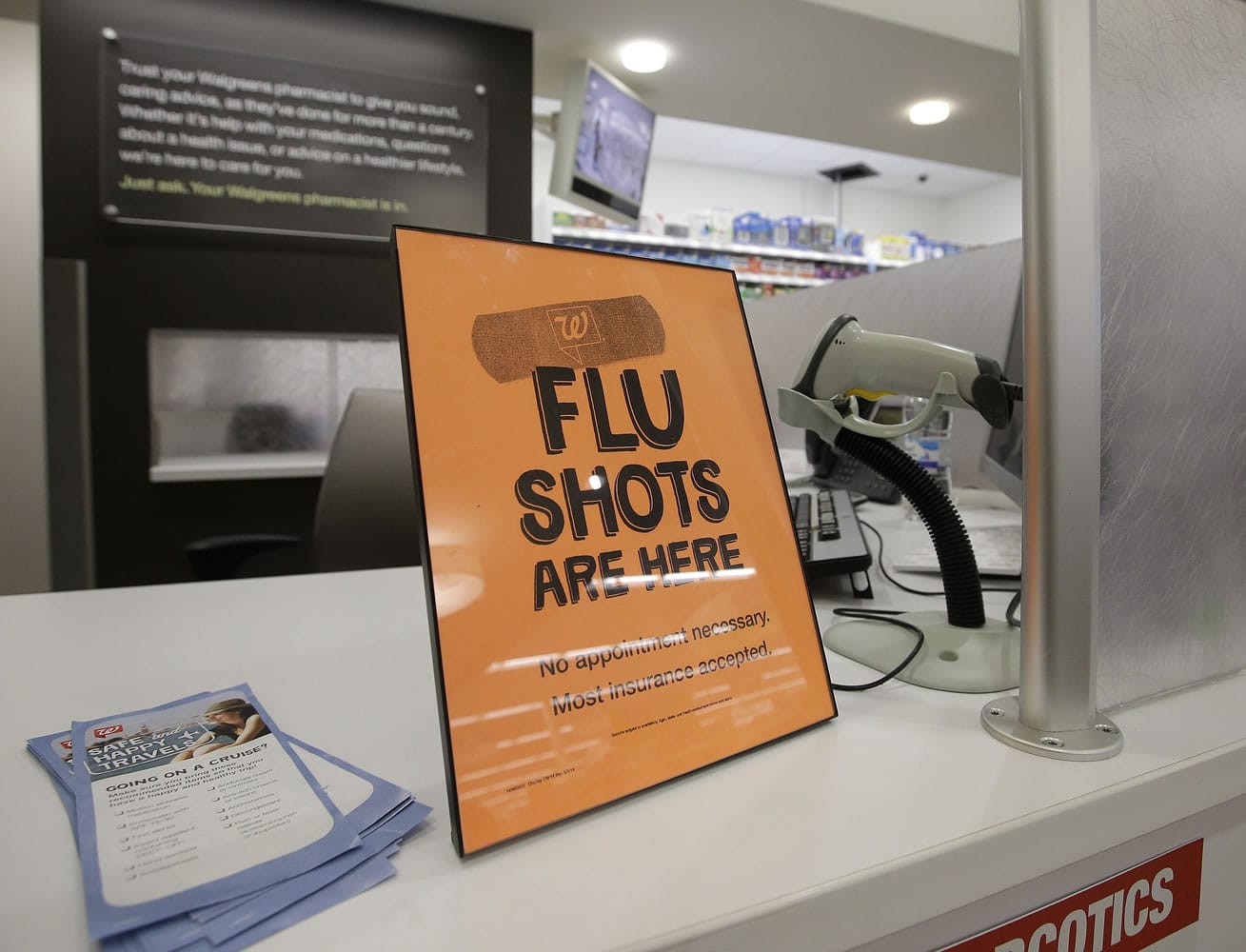 A sign lets customers know they can get a flu shot in a Walgreen store in Indianapolis.