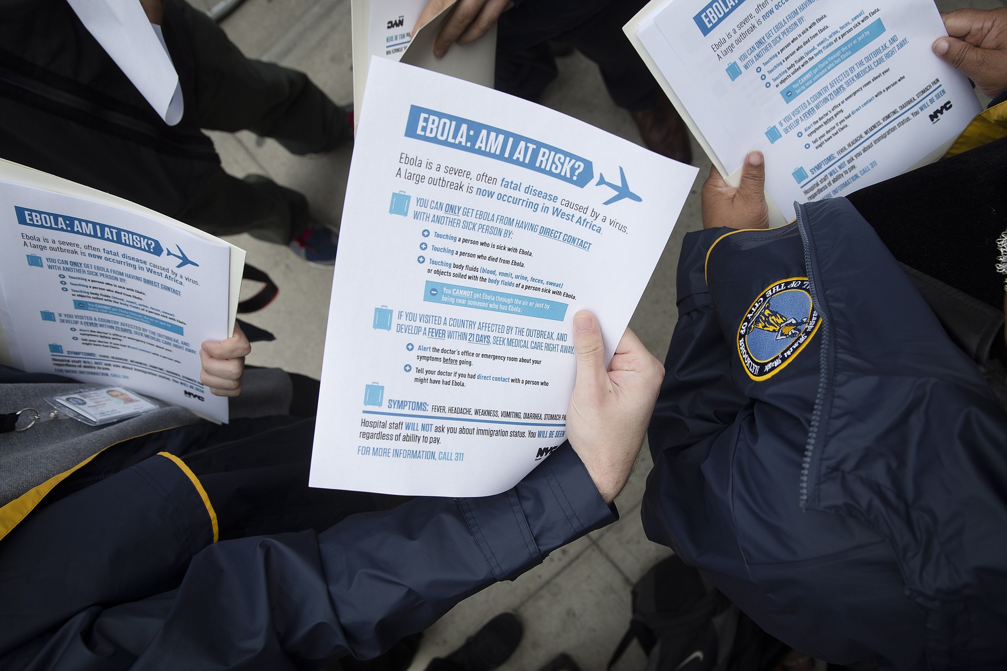 Members of the Brooklyn Borough President's office hand out fliers detailing the risks of Ebola outside The Gutter bowling alley in the Williamsburg neighborhood of the Brooklyn borough of New York.