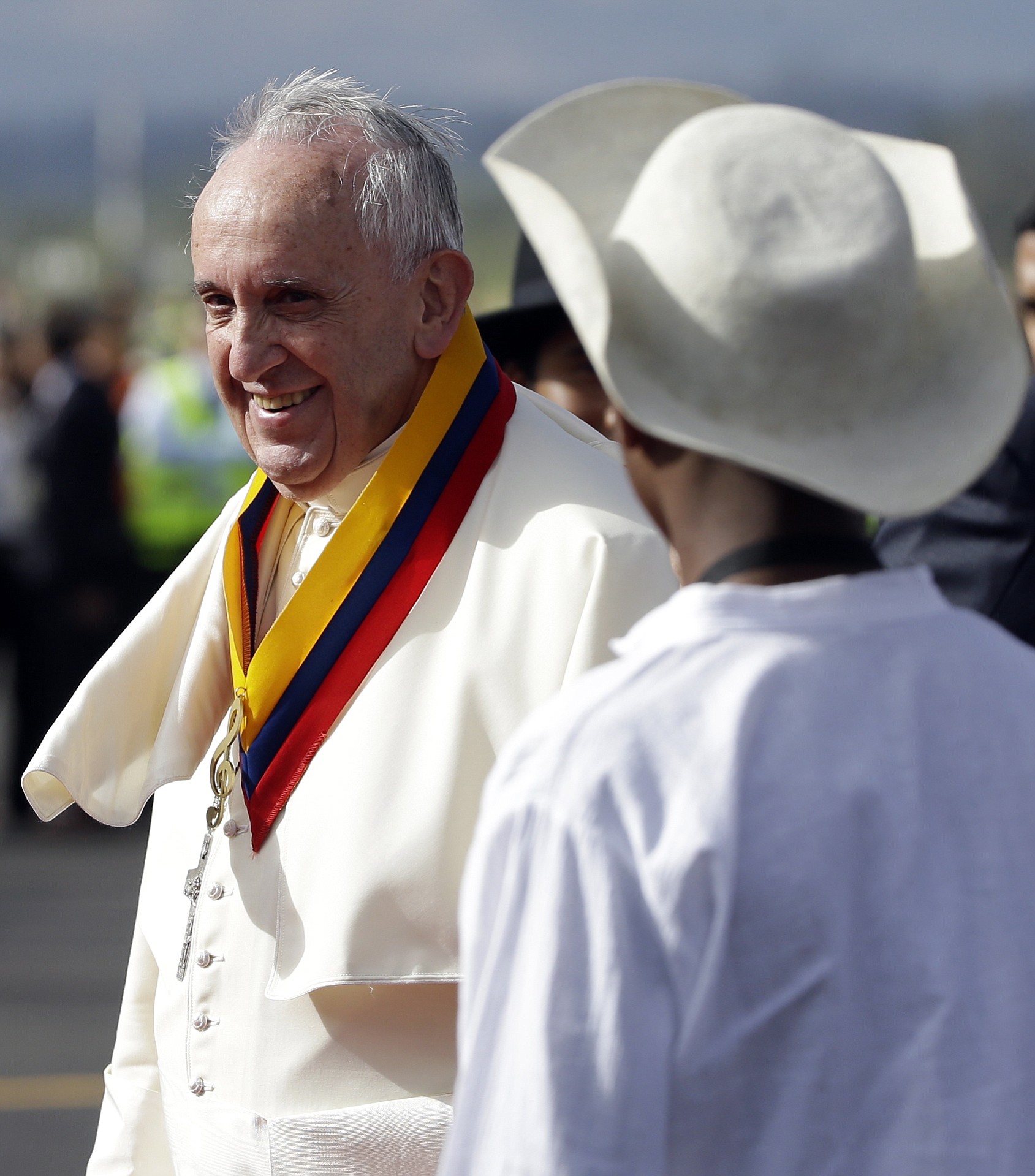Pope Francis is welcomed by children in traditional costumes on his arrival Sunday to the Mariscal Sucre International Airport in Quito, Ecuador.