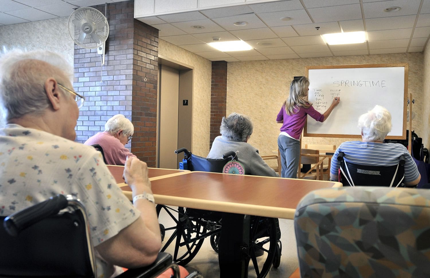 Tina Reese leads a word game for residents at a nursing home in Lancaster, Pa.