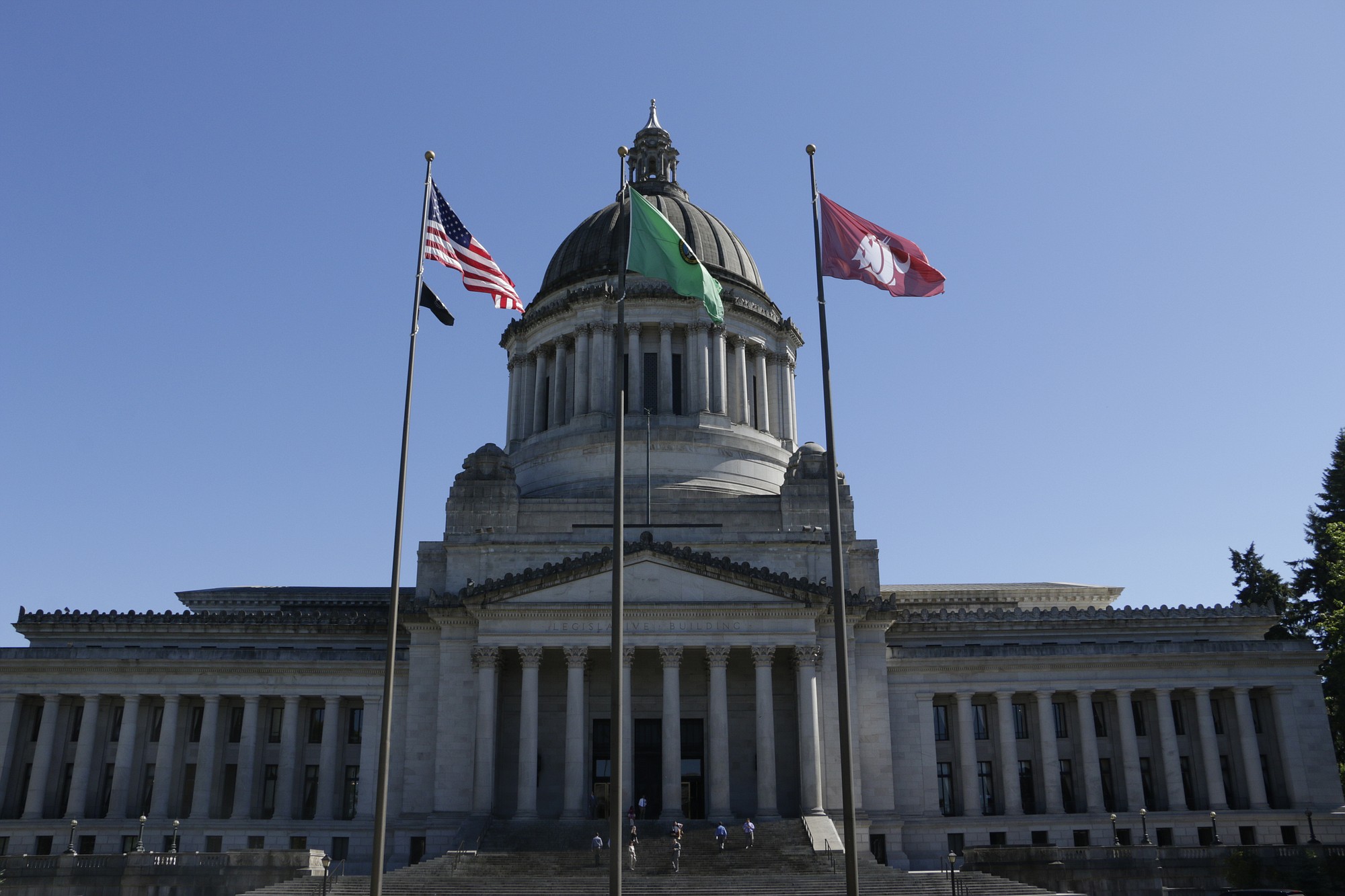 The flag of Washington State University flies in front of the state Capitol in honor of the school's late president, Elson Floyd on June 25 in Olympia.