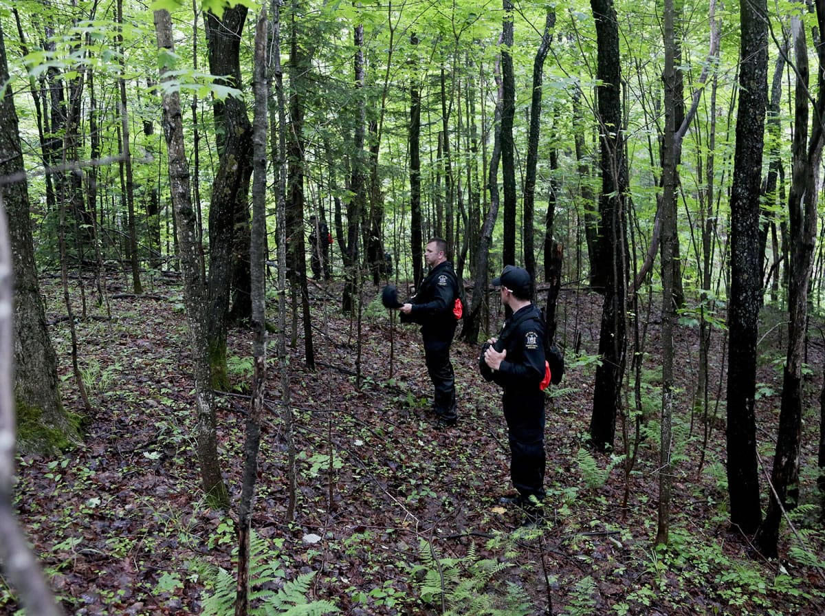 Corrections officers search the woods Tuesday in Owls Head, N.Y., for two escapees from the Clinton Correctional Facility.