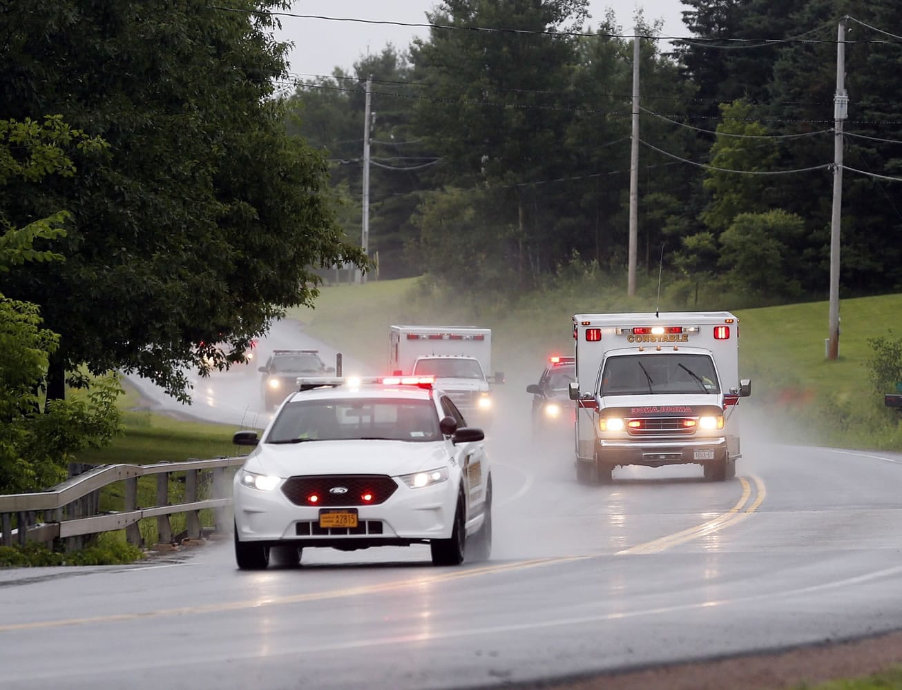 Police escort ambulances from an area where law enforcement officers were searching for convicted murderer David Sweat, one of two convicted murderers who broke out of a maximum-security prison near the Canadian border, on Sunday in Constable, N.Y.