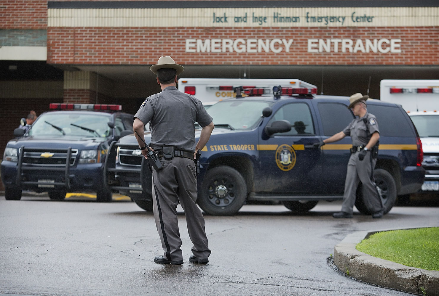 Law enforcement officers stands outside Alice Hyde Medical Center in Malone, N.Y., on Sunday, where David Sweat was taken after being shot and captured. Sweat's capture came two days after his fellow escapee, Richard Matt, was killed in a confrontation with law enforcement while holding a shotgun.