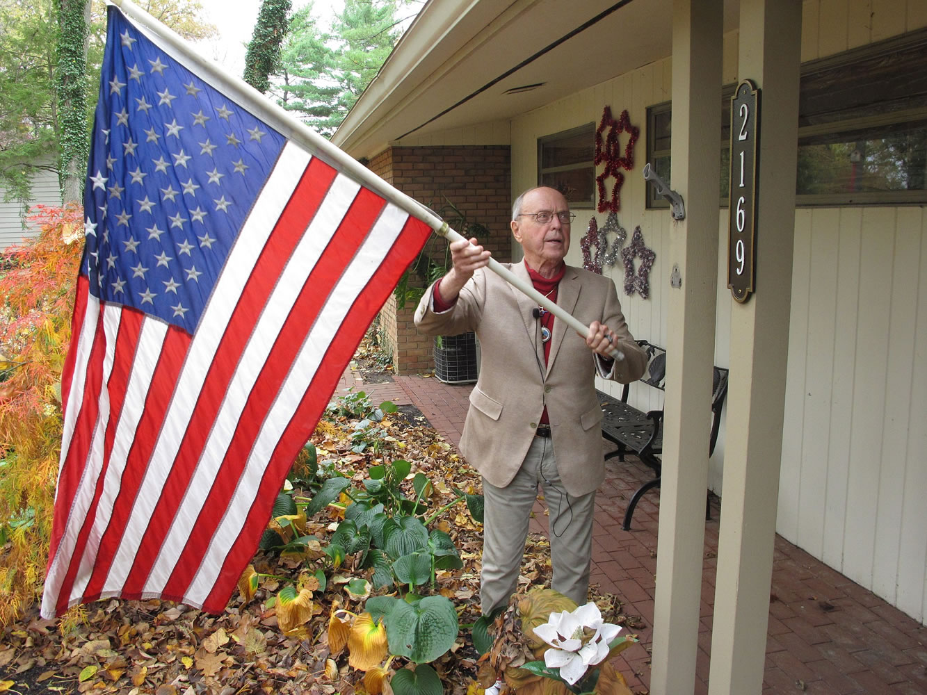 Rupert &quot;Twink&quot; Starr adjusts a flag last month at his house in Upper Arlington, Ohio.