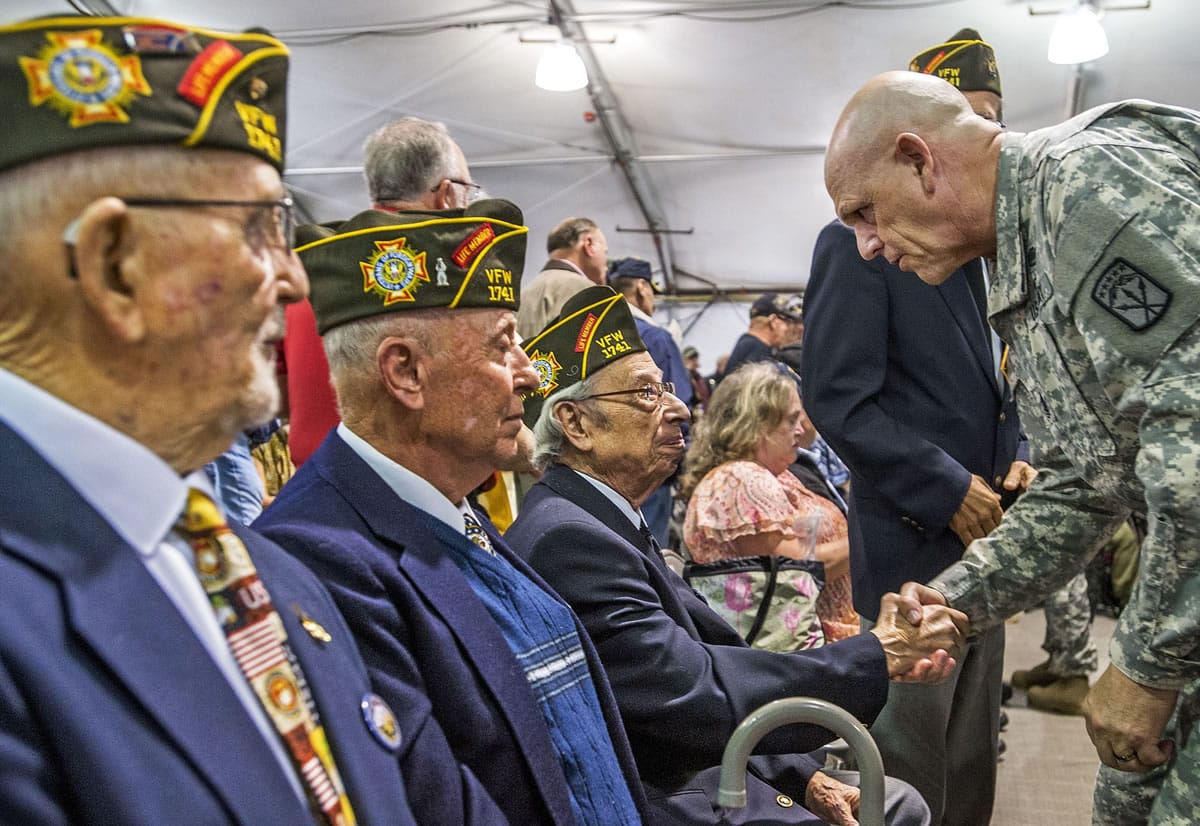 Command Sgt. Major Erik Frey awards commemorative pins to Auburn VFW Vietnam-era veterans John Pepper, from left, Bob Newman, and Joe Audino during a Thursday ceremony at Joint Base Lewis McChord. It part of the 50th Anniversary Commemoration of the Vietnam War.