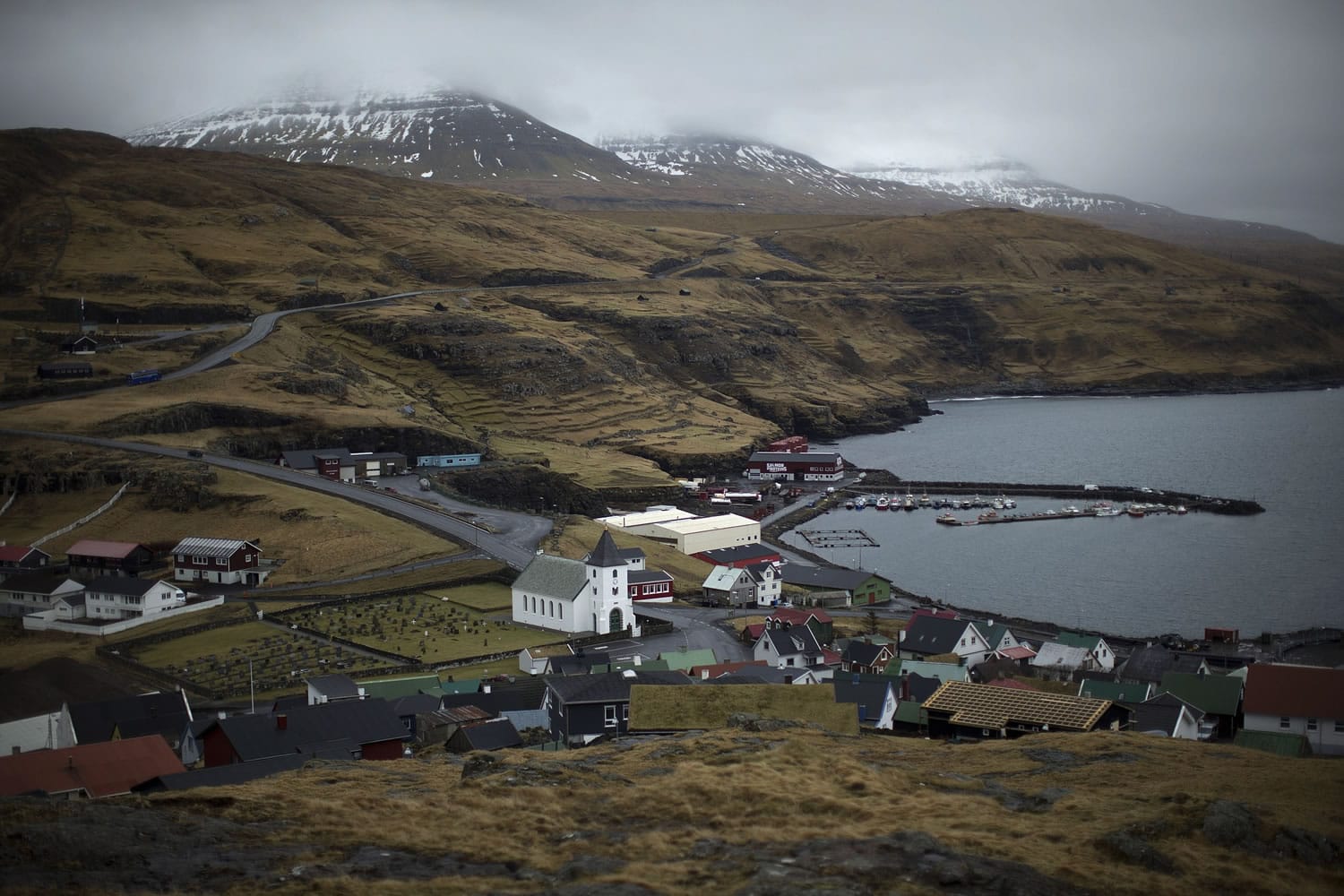 Cloudy skies hang over the hills overlooking the town of Eidi in the north of the Faeroe Islands on Thursday.