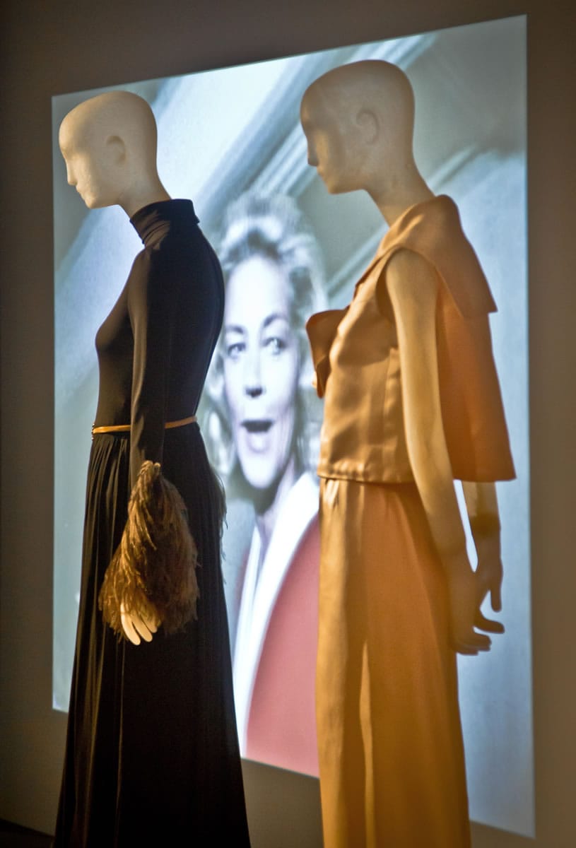 A projection of the late actress Lauren Bacall is flanked by mannequins wearing her designer garments, Christian Dior, left, and Norman Norell, in &quot;Lauren Bacall: The Look&quot; in New York.