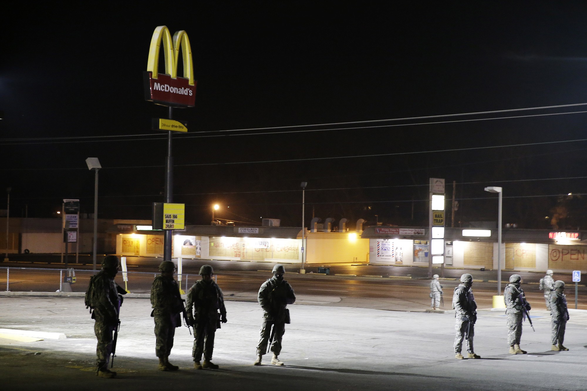 Missouri National Guard stand watch at a stretch of businesses that were damaged in the riots following Monday's grand jury announcement on Wednesday in Ferguson, Mo.