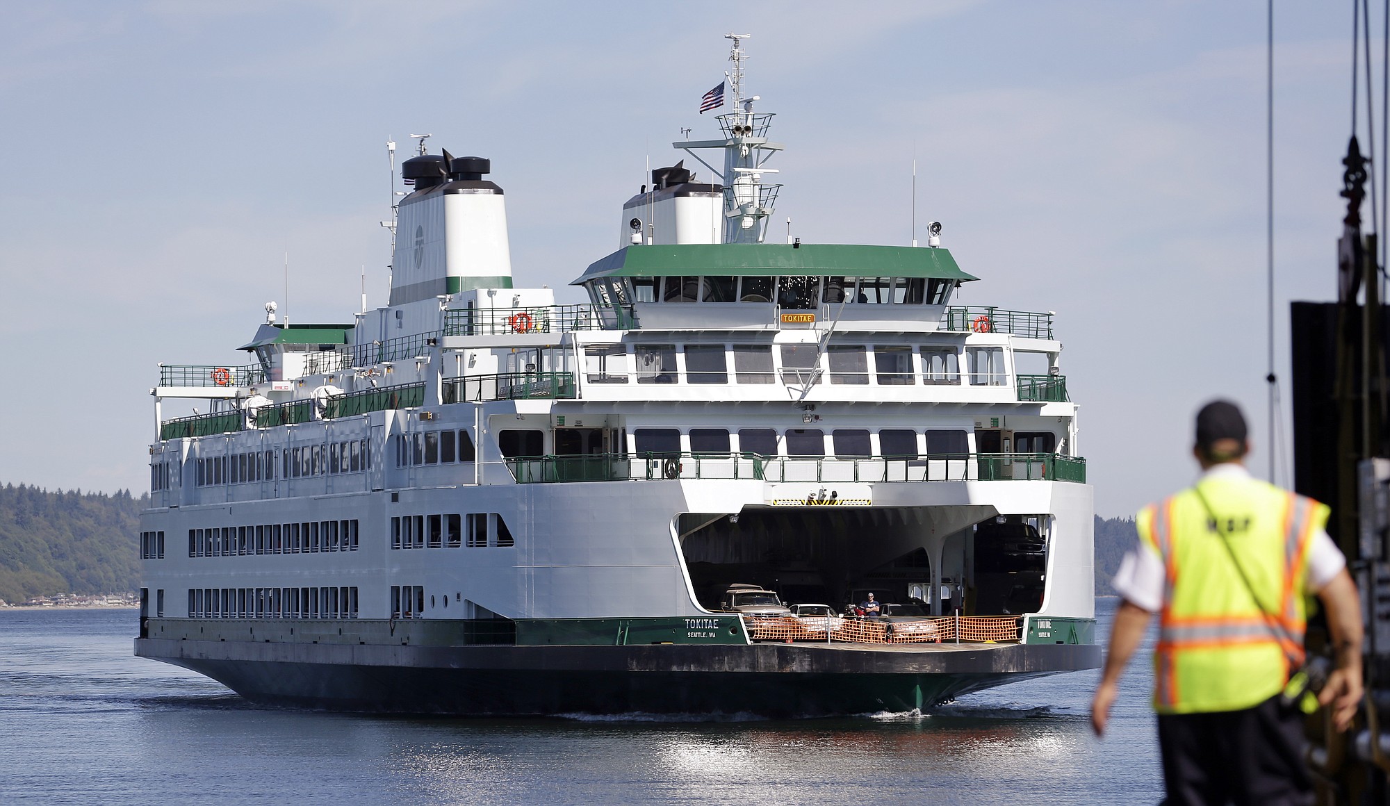 The Tokitae, Washington's newest ferry, heads into the dock on a run from Clinton, Wash., Tuesday, July 1, 2014, in Mukilteo, Wash. After a two week delay for additional crew training, the Tokitae entered service about noon Monday on the busy Mukilteo-Clinton run, but had a problem with some cars scraping bottom on the edge of ramps. Tuesday, a small hydraulic leak forced it to cancel its first round trip of the morning for repairs and a sea trial. To avoid the scraping, crews are now sorting vehicles by size and weight and direct them either to the main deck or side ramps.