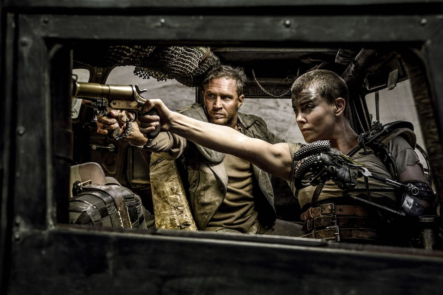 Tom Hardy, left, as Max Rockatansky and Charlize Theron as Imperator Furiosa take aim in &quot;Mad Max: Fury Road.&quot;