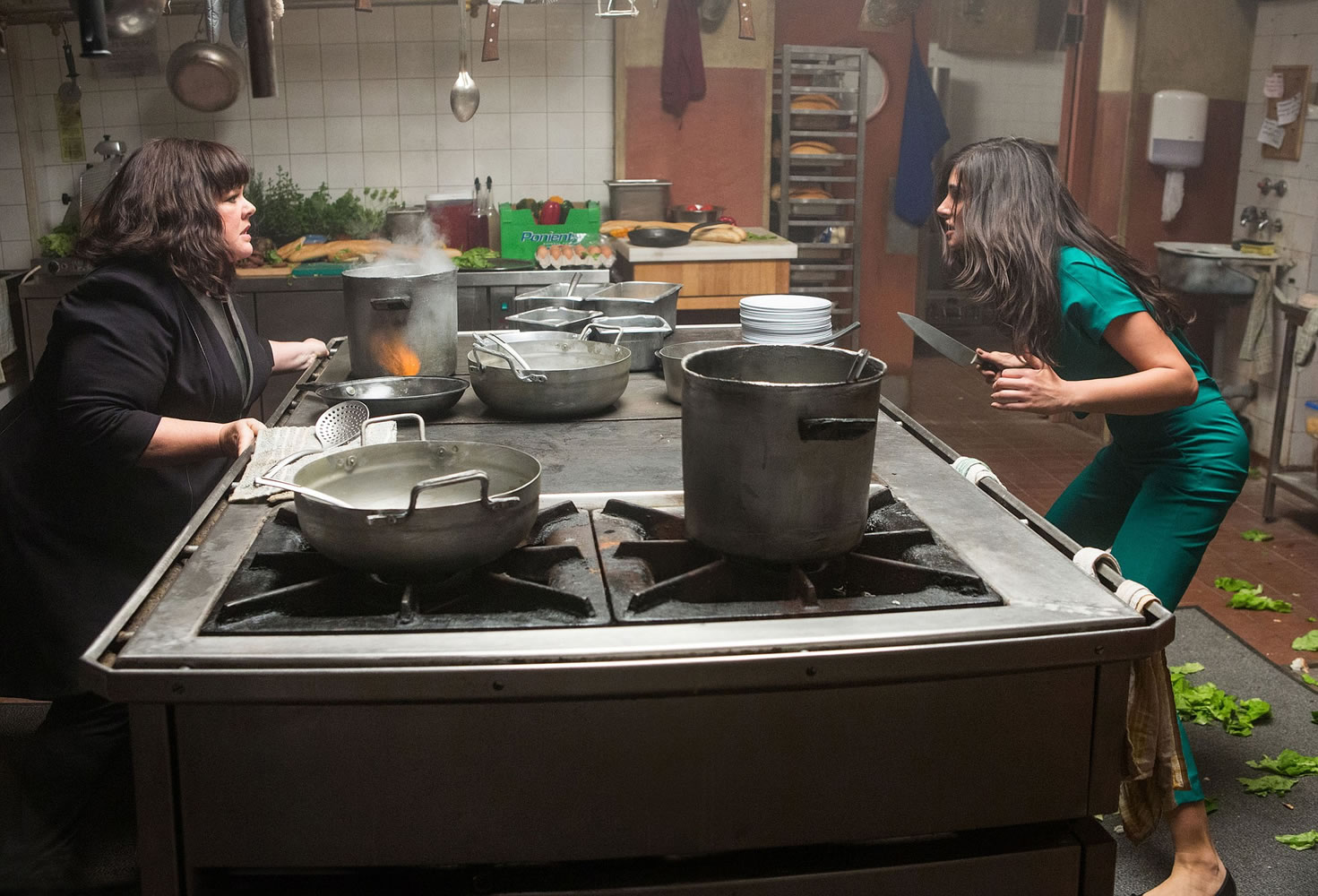 Melissa McCarthy, left, faces a knife-wielding adversary, Nargis Fakhri, in &quot;Spy.&quot;