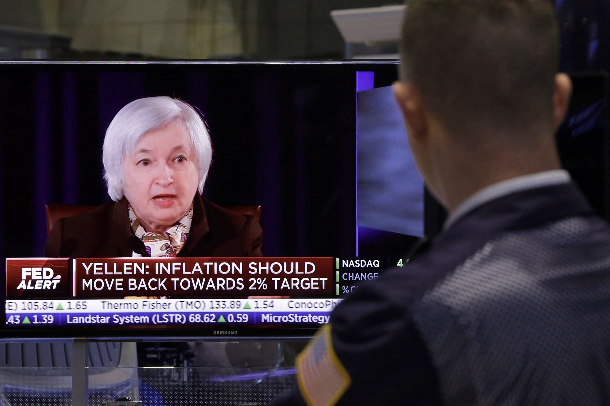 A trader on the floor of the New York Stock Exchange watches Federal reserve Chair Janet Yellen's news conference Wednesday.