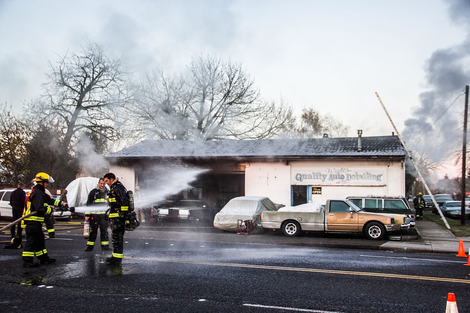 Emergency crews respond to a fire Sunday morning at Walt's Quality Auto Detailing on Main Street in Vancouver.