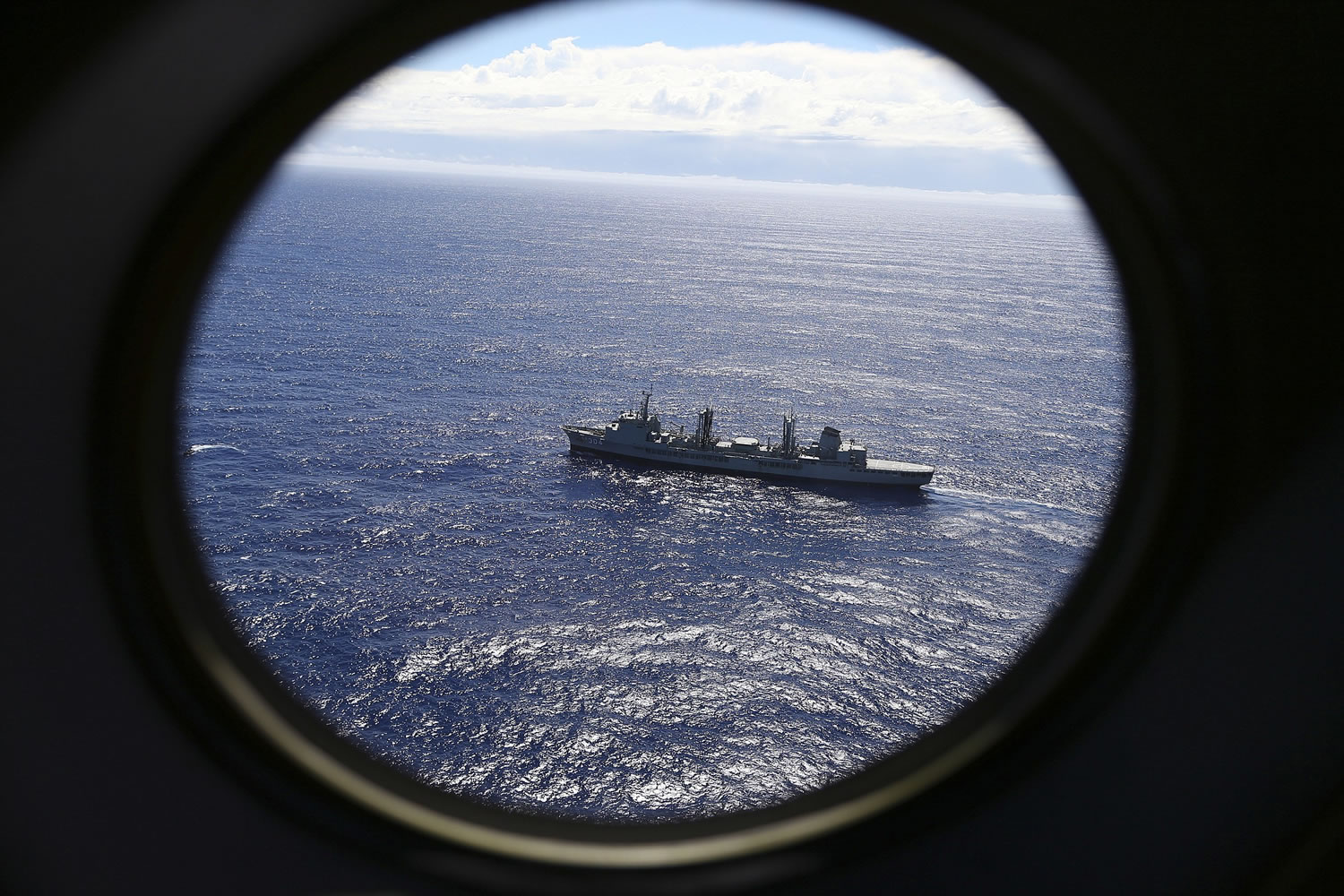 Associated Press files
A ship, HMAS Success, is viewed from a Royal New Zealand Air Force P3 Orion while both search for the missing Malaysia Airlines Flight 370 in March 2014.