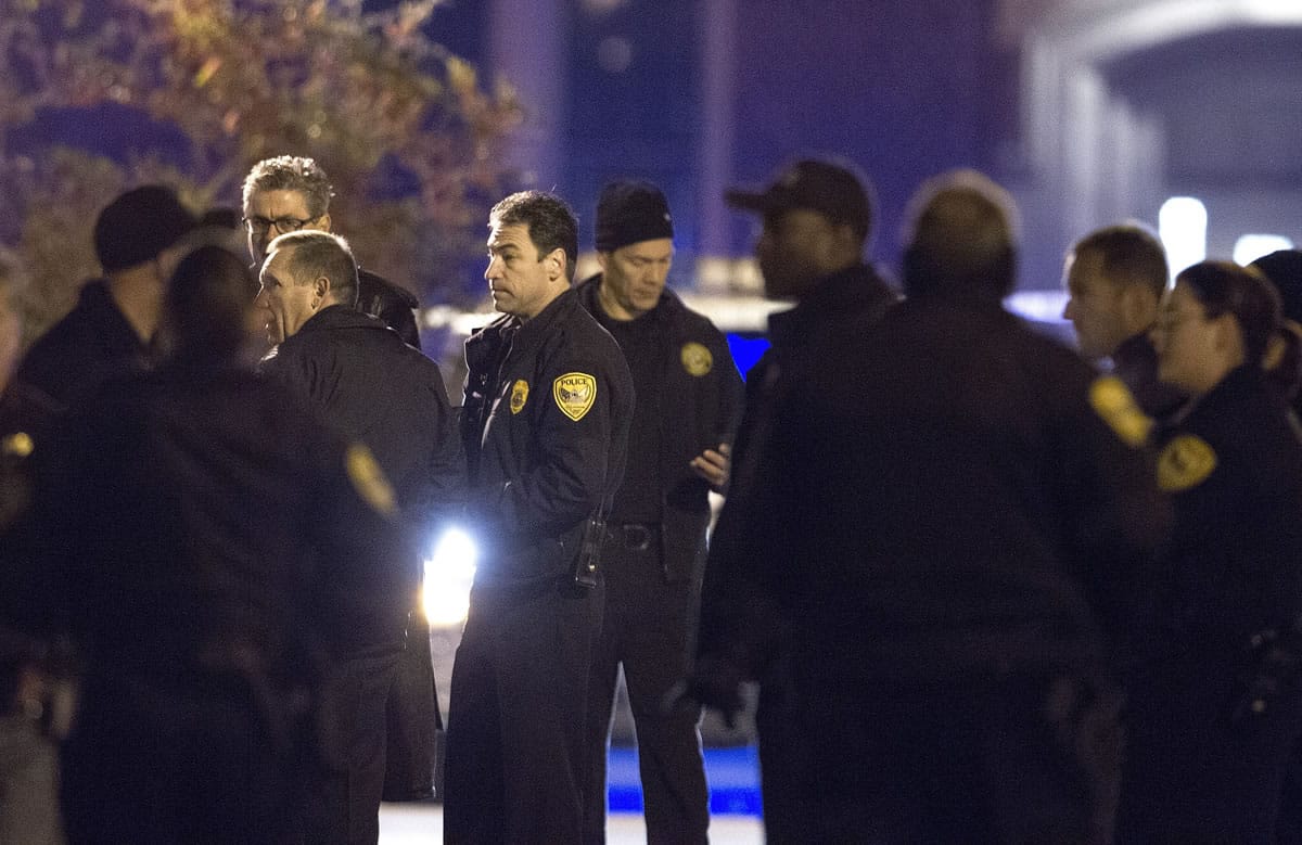 Tallahassee police chief Michael Deleo, center, talks with his officers as they investigate a shooting outside the Strozier library on the Florida State University campus in Tallahassee, Fla. Nov 20, 2014.   The gunman was shot and killed by police officers according to Tallahassee Police spokesman Dave Northway.