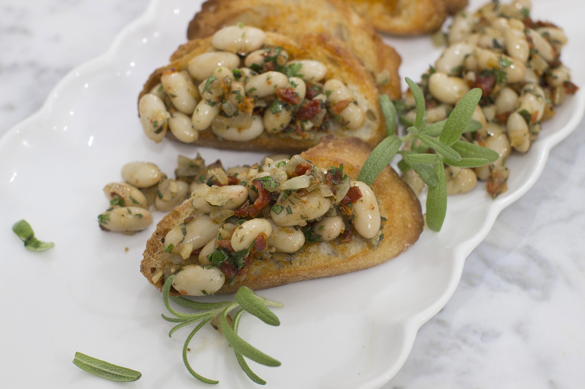 In Italy, a reliance on whole ingredients and bold flavors means there are plenty of small bites -- such as this Winter White Bean Bruschetta.