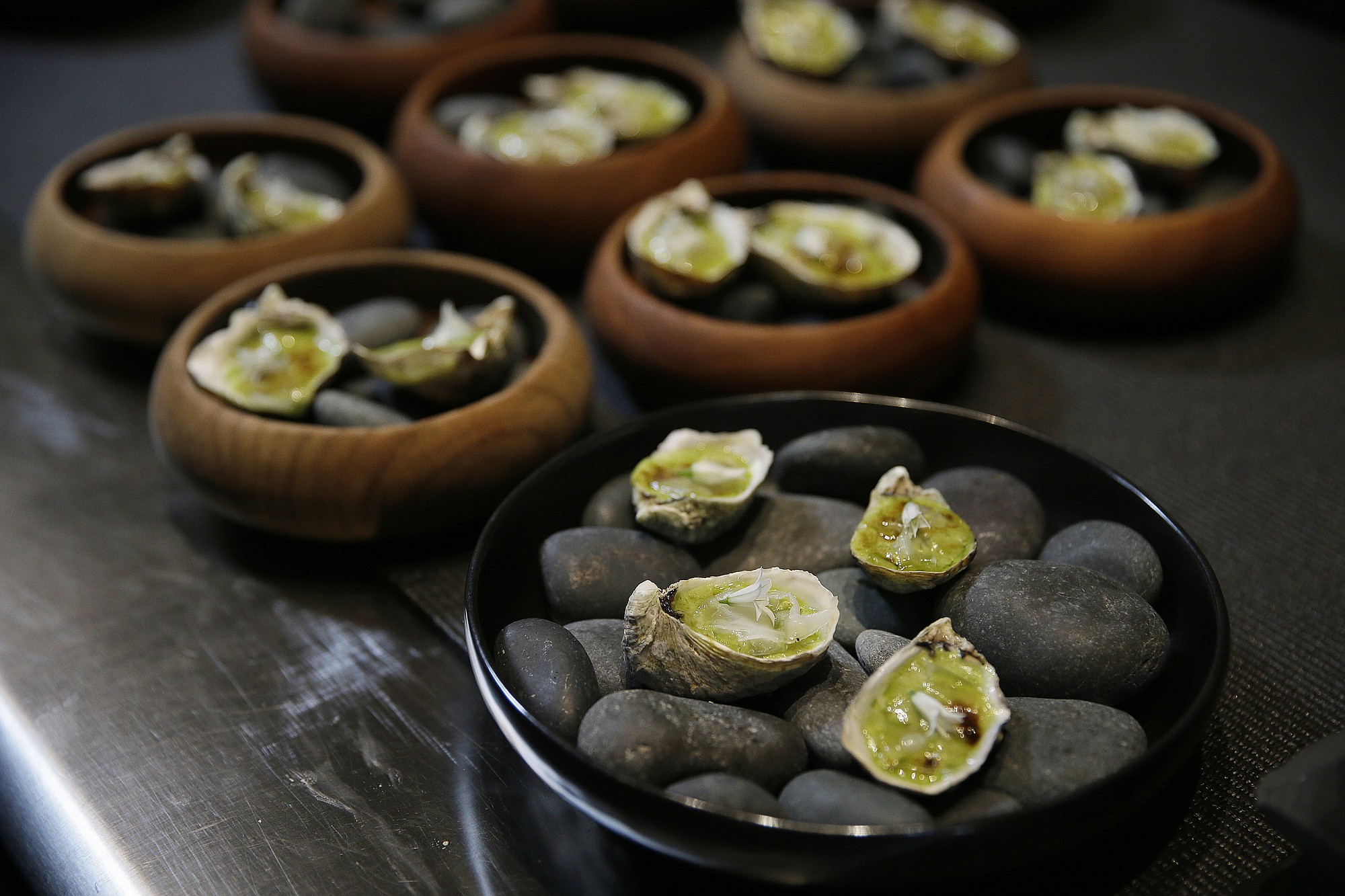 A &quot;snack&quot; of broiled Shigoku oyster is ready to be served at the Lazy Bear restaurant in San Francisco.