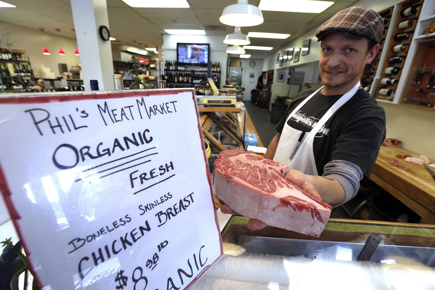 Butcher Brandon Rice shows a cut of antibiotic-free steak at Phil's Meat Market in Portland on Friday.