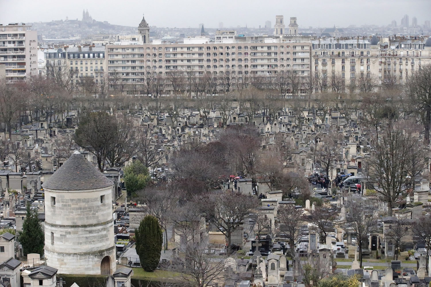 Aerial view of the Montparnasse cemetery as relatives gather for the burial of late French cartoonist Georges Wolinski at Montparnasse cemetery in Paris on Thursday.