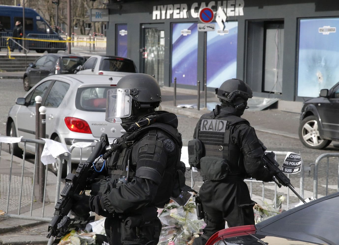 Elite police officers take position outside the kosher market where four hostages were killed and shortly before Israeli Prime Minister Benjamin Netanyahu's visit to the site, in Paris.