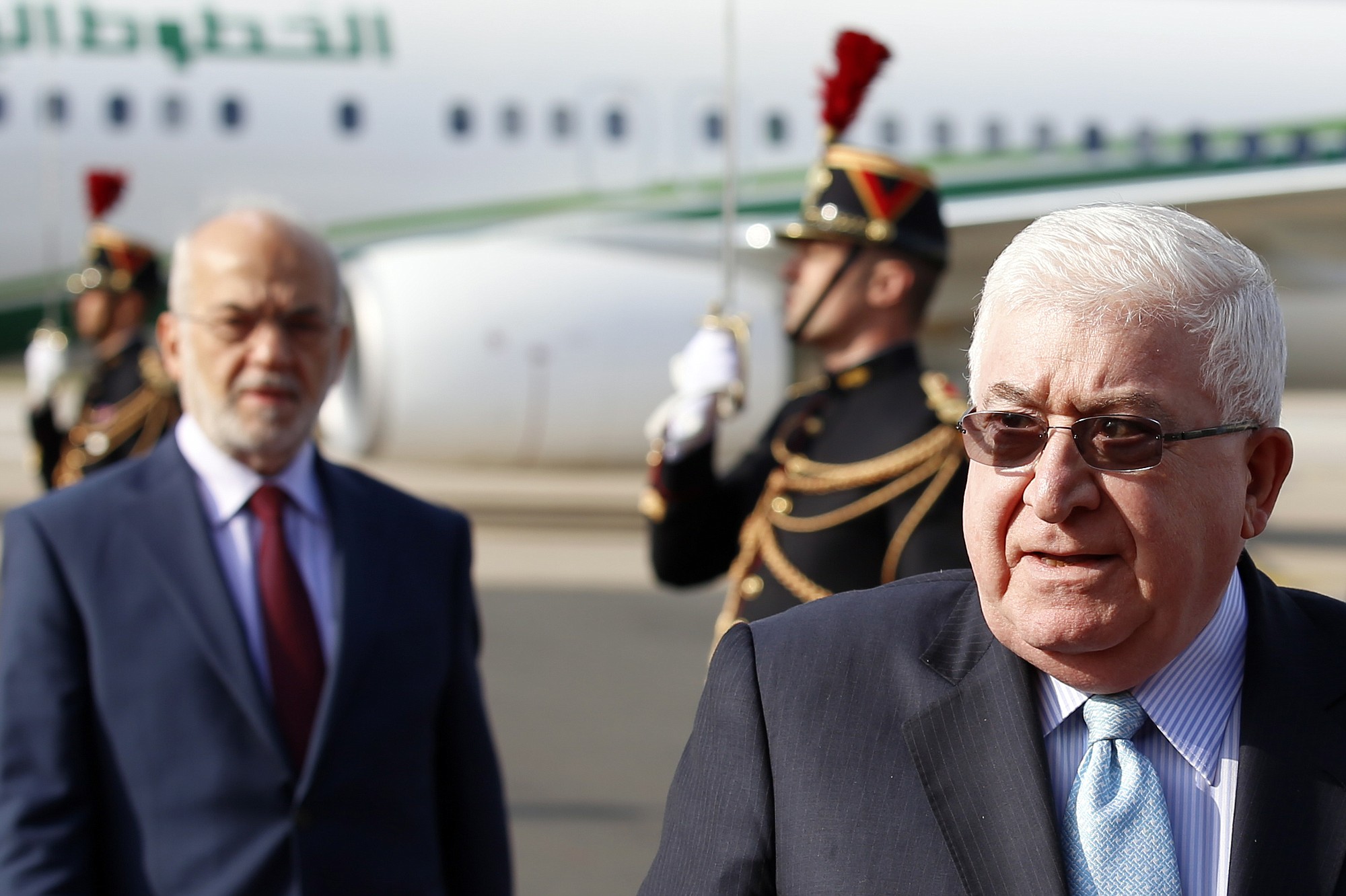 Fran?ois Mori/Associated Press
Iraq President Fouad Massoum, right, followed by Iraq Foreign Minister Ibrahim Al-Jaafari, arrive Sunday with Iraqi officials at Orly airport south of Paris ahead of a conference with diplomats from around the world.