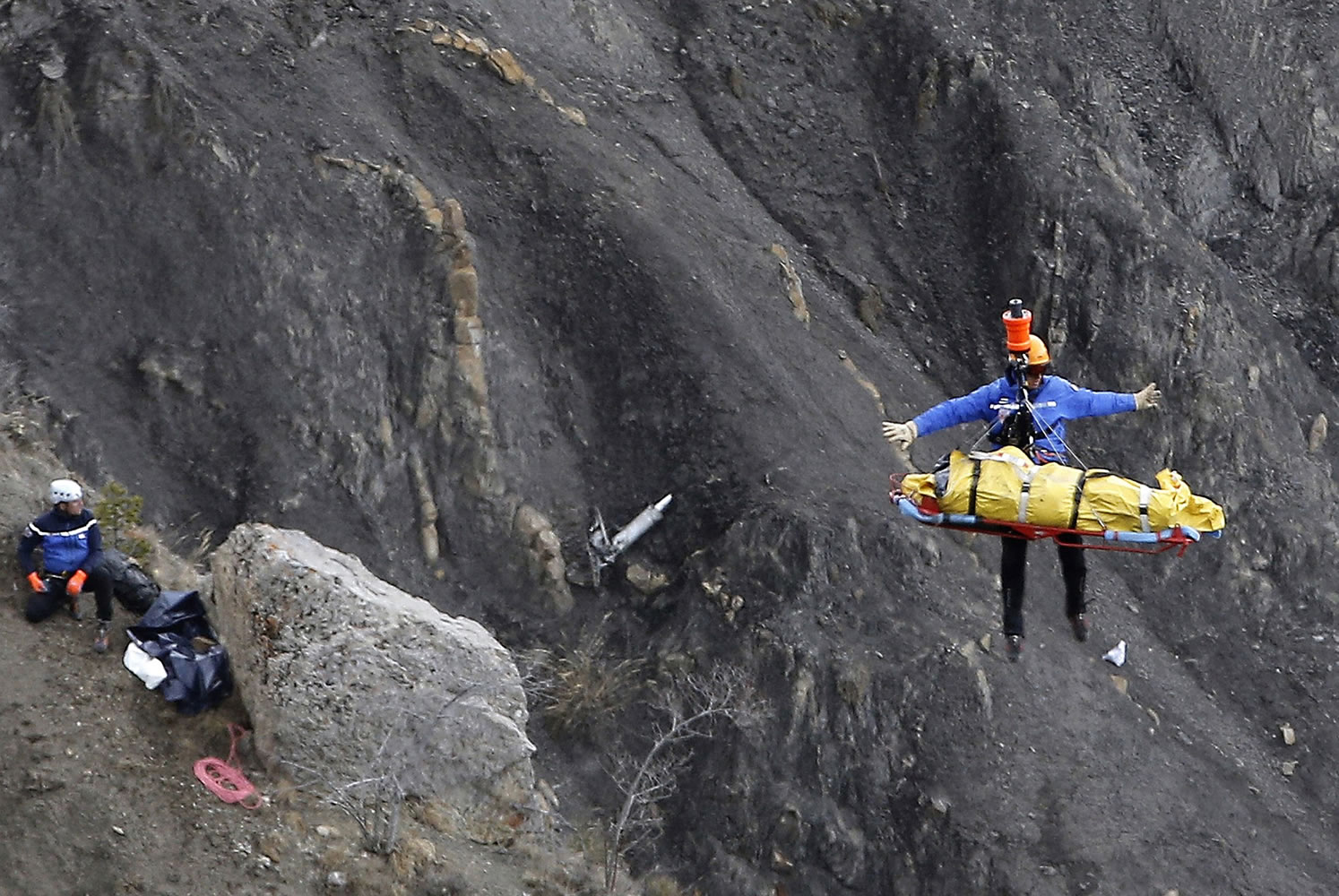 A rescue worker is lifted into a helicopter Thursday at the crash site near near Seyne-les-Alpes, France.