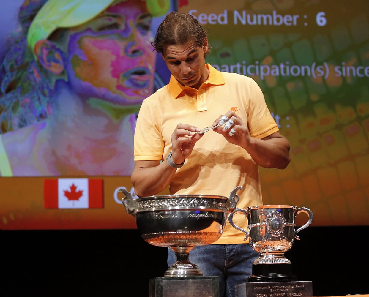 Defending champion Spain's Rafael Nadal picks a token during the draw for the French Tennis Open at the Roland Garros stadium, Friday, May 22, 2015 in Paris. The French Open starts Sunday.
