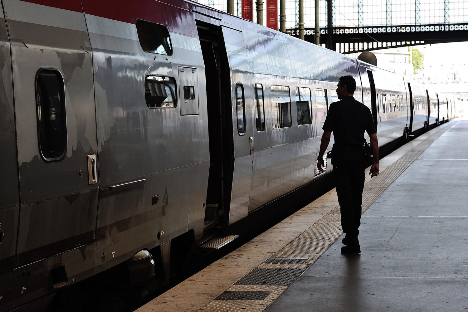 A French police officer patrols at Gare du Nord train station Saturday in Paris, France.