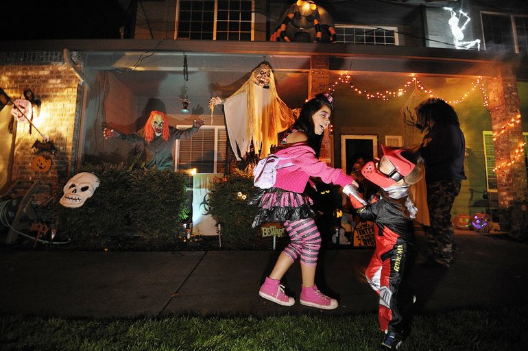 What's better than a good scare on Halloween night? Here, Brianna Molina, 10, and her nephew, Carlos, 5, of Vancouver react as Jay Morin, background left, jumps from a bush at the Morin home in Felida on Monday night.