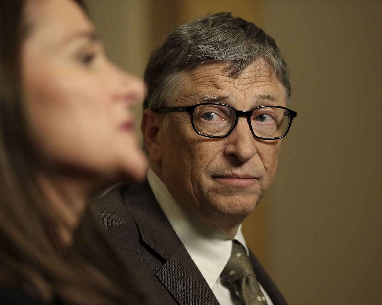 Bill Gates listens to his wife, Melinda Gates, Wednesday in New York.