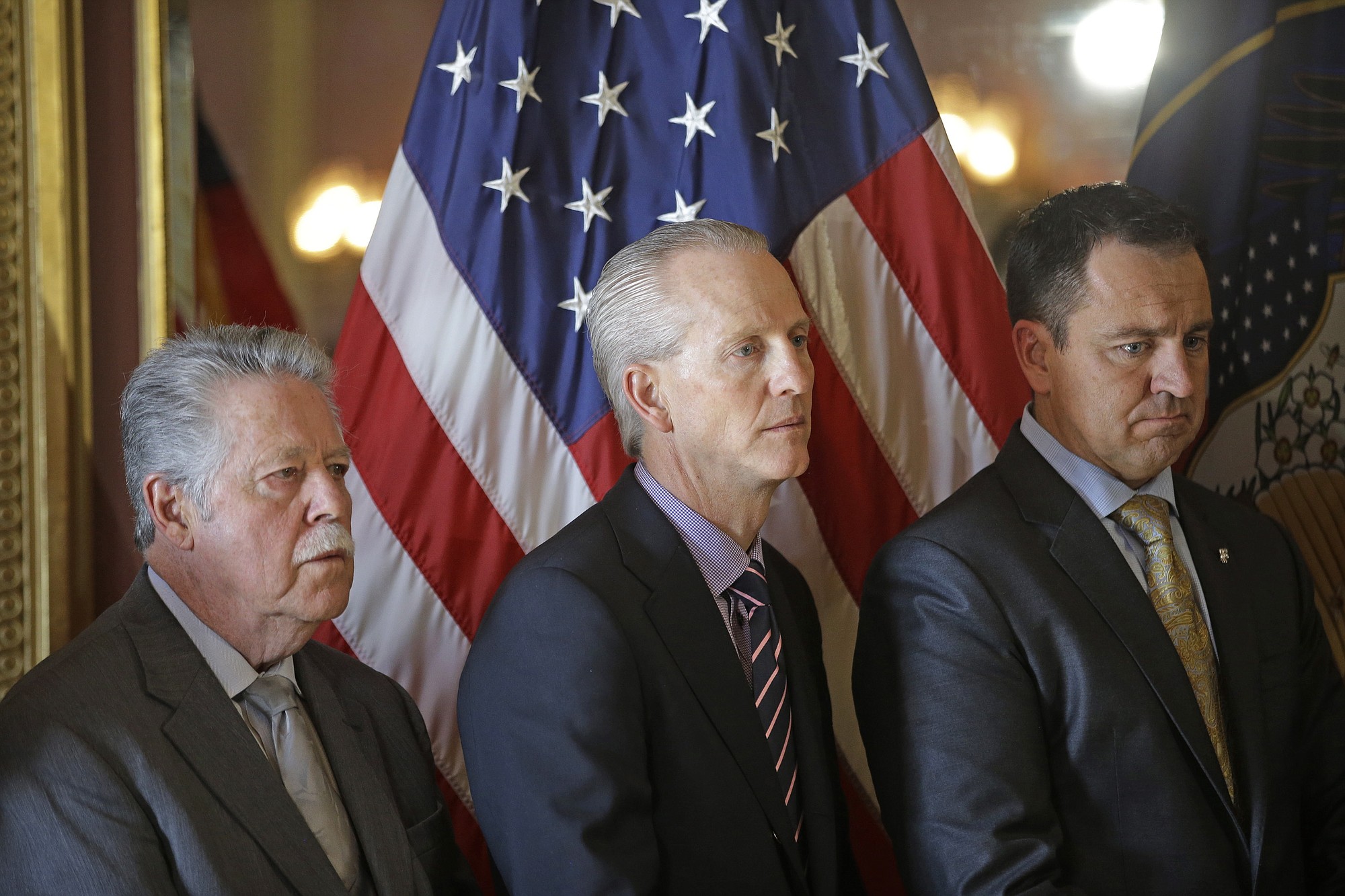 Minority leader Sen. Gene Davis, D- Salt Lake, left, Senate President Wayne Niederhauser, R-Sandy, center, and House Speaker Greg Hughes, R-Draper, listen during a news conference at the Utah State Capitol  Wednesday, March 4, 2015, in Salt Lake City. Utah lawmakers introduced a landmark anti-discrimination bill Wednesday that protects LGBT individuals while also carving out protections for the Boy Scouts of America and religious groups.