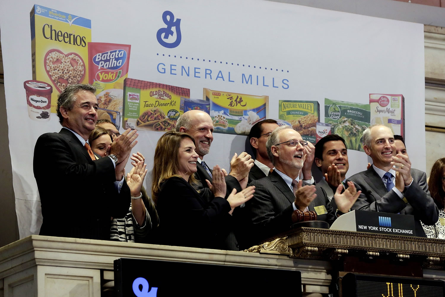General Mills Chairman  and CEO Kendall Powell, second from right, joins in applause as he rings the New York Stock Exchange Tuesday opening bell.