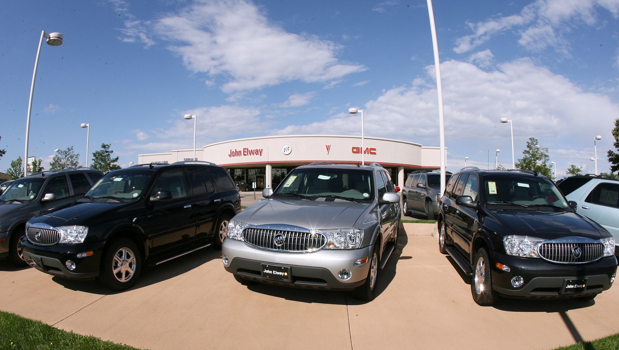 A trio of unsold 2006 Buick Rainier sports utility vehicles sits in front of a Buick dealership in the southeast Denver suburb of Lone Tree, Colo.