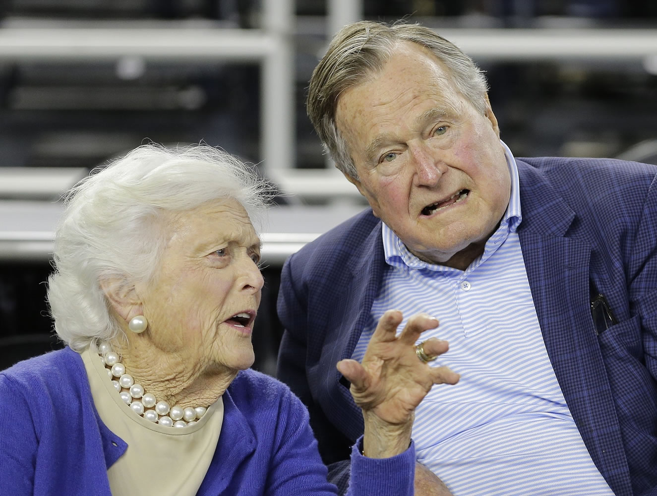 Former President George H.W. Bush and his wife, Barbara, speak in March before the first half of an NCAAA college basketball game in Houston. A spokesman says doctors are pleased with the progress the former president is making since he fractured a bone in his neck during a fall.