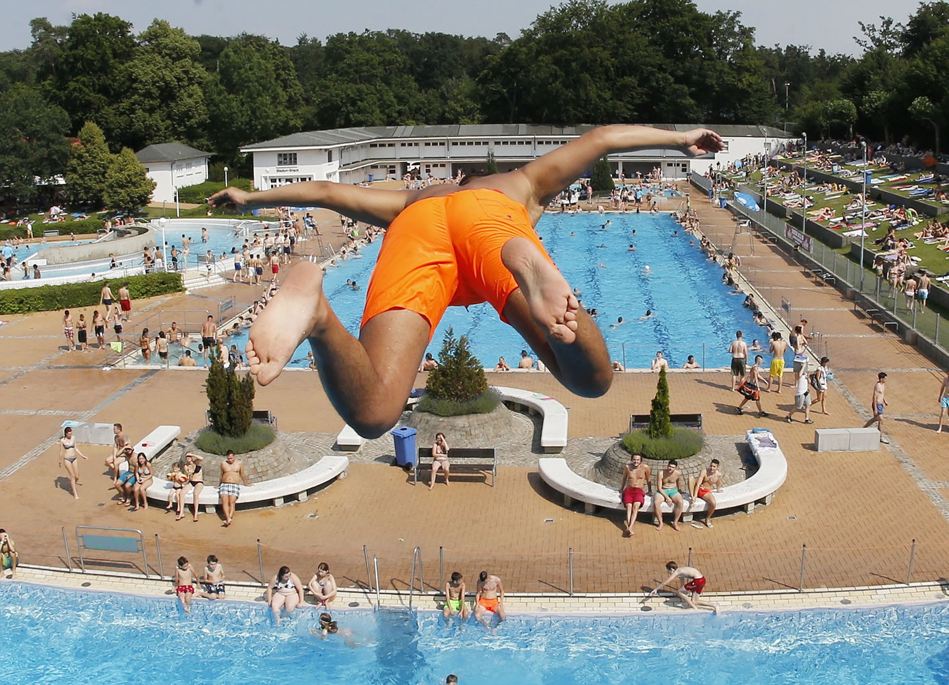 A boy jumps from a 7.5-meter platform into a pool Friday in Frankfurt, Germany.