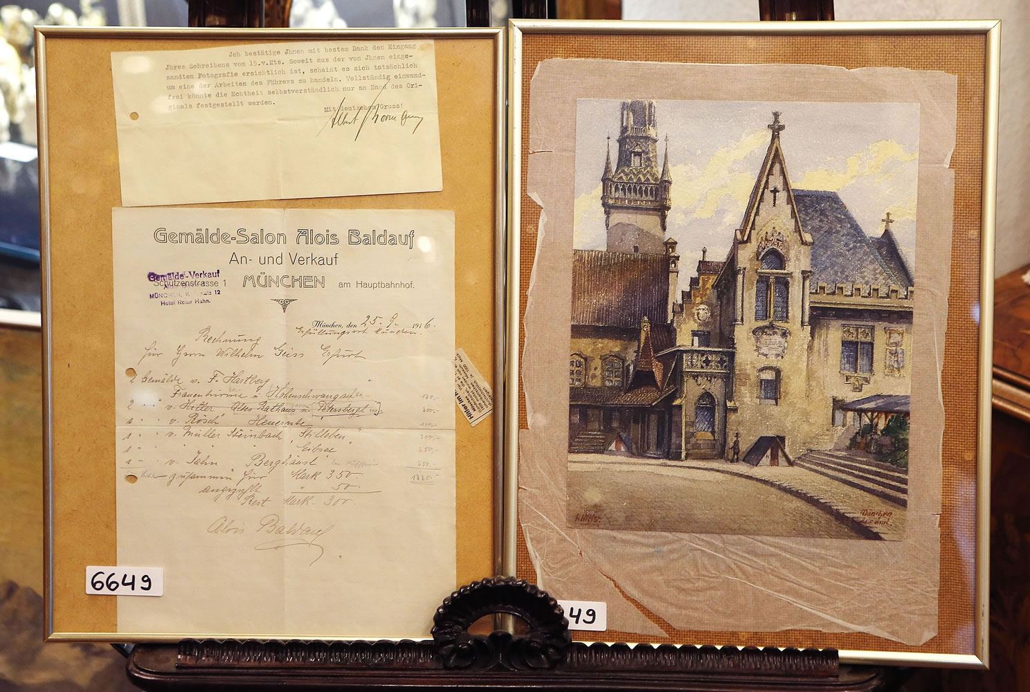 The Wednesday, Nov. 19, 2014 photo shows a picture titled  &quot;The Old City Hall,&quot; right, that - as the auction house in Nuremberg, Germany, said - was painted by Adolf Hitler and the original bill of sale and a signed letter, left,  from Hitler's adjutant Albert Bormann, brother of the better-known Martin Bormann. The 100-year-old watercolor of Munich's city hall is expected to fetch at least 50,000 euros (US$ 60,000) at auction this weekend, not so much for its artistic value as for the signature in the bottom left corner.