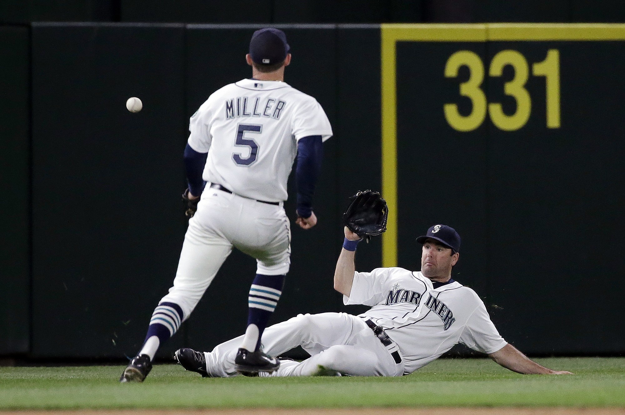 Seattle Mariners left fielder Seth Smith can't get to the ball, while shortstop Brad Miller (5) watches on a single by San Francisco Giants' Angel Pagan during the eighth inning Thursday, June 18, 2015, in Seattle.