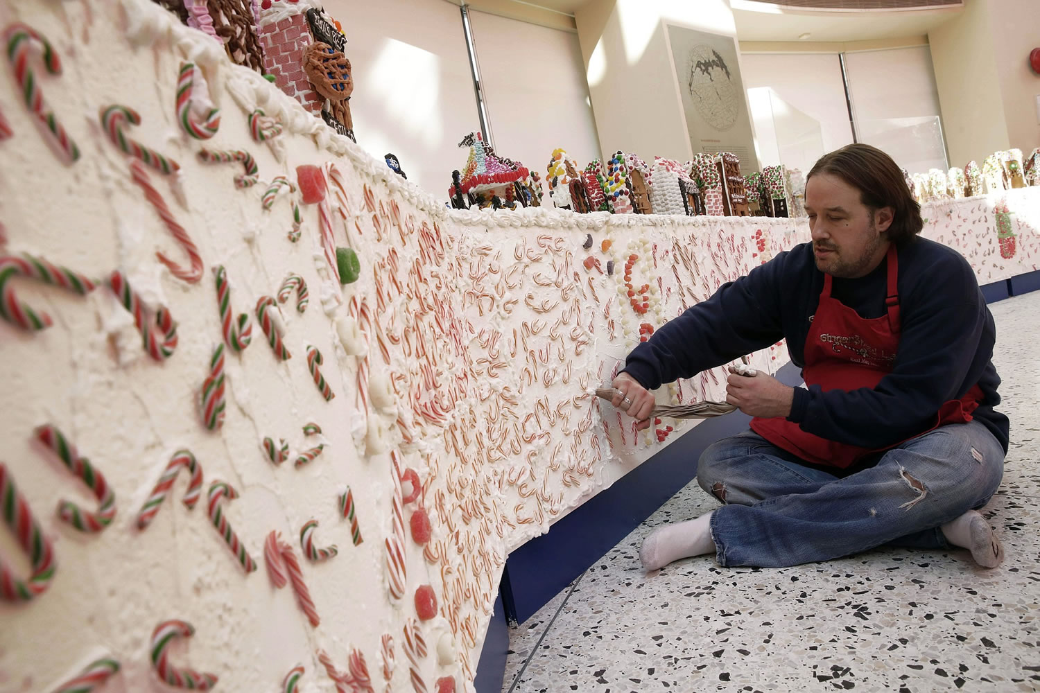 Chef Jon Lovitch uses a pastry bag of frosting Nov. 13 as he prepares the border for his GingerBread Lane display, at the New York Hall of Science, in the Queens borough of New York.