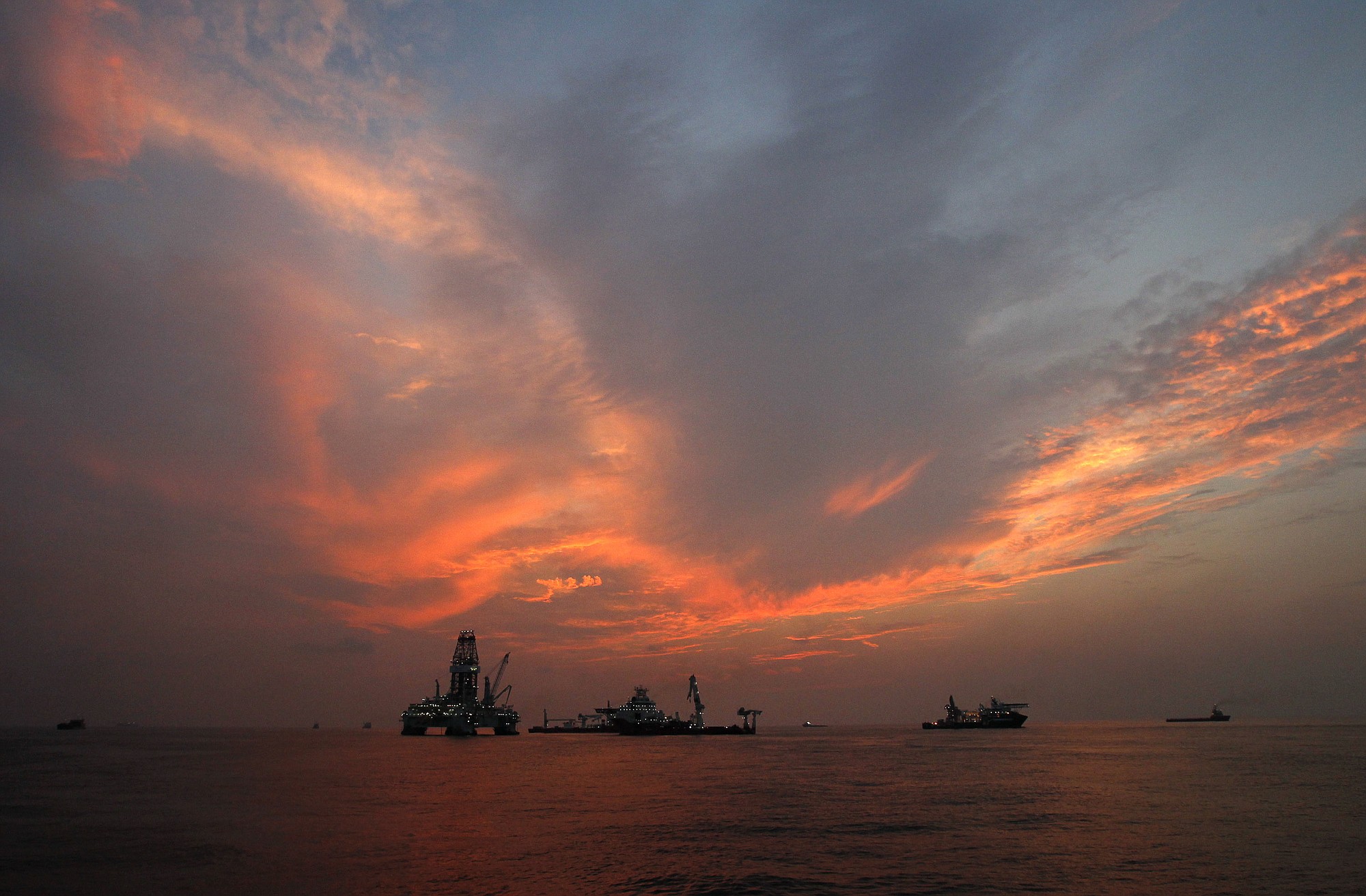 Vessels assist in the drilling of the Deepwater Horizon relief well on the Gulf of Mexico near the coast of Louisiana at sunset on Sept.