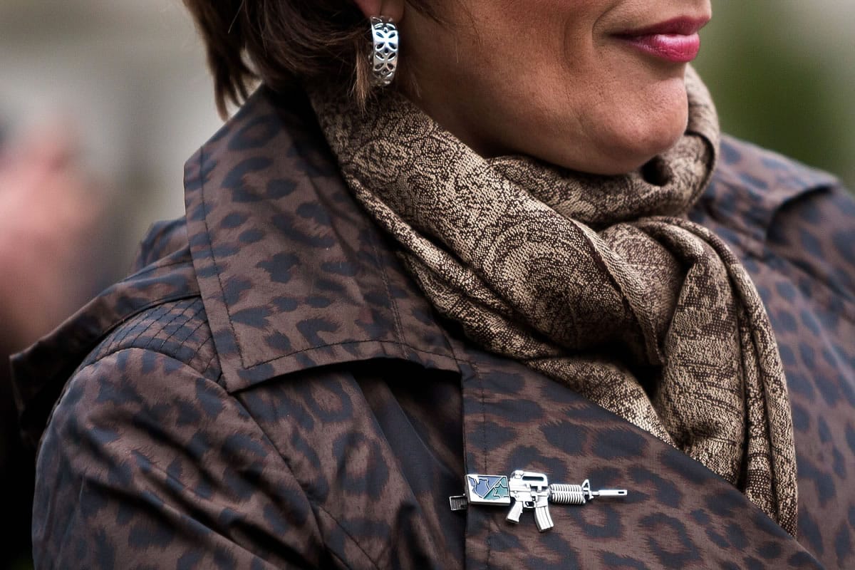 State Rep. Liz Pike, R-Camas, wears a firearm pin as she joins dozens of demonstrators for a rally Thursday against Initiative 594 on the front steps of the Washington Capitol building in Olympia.