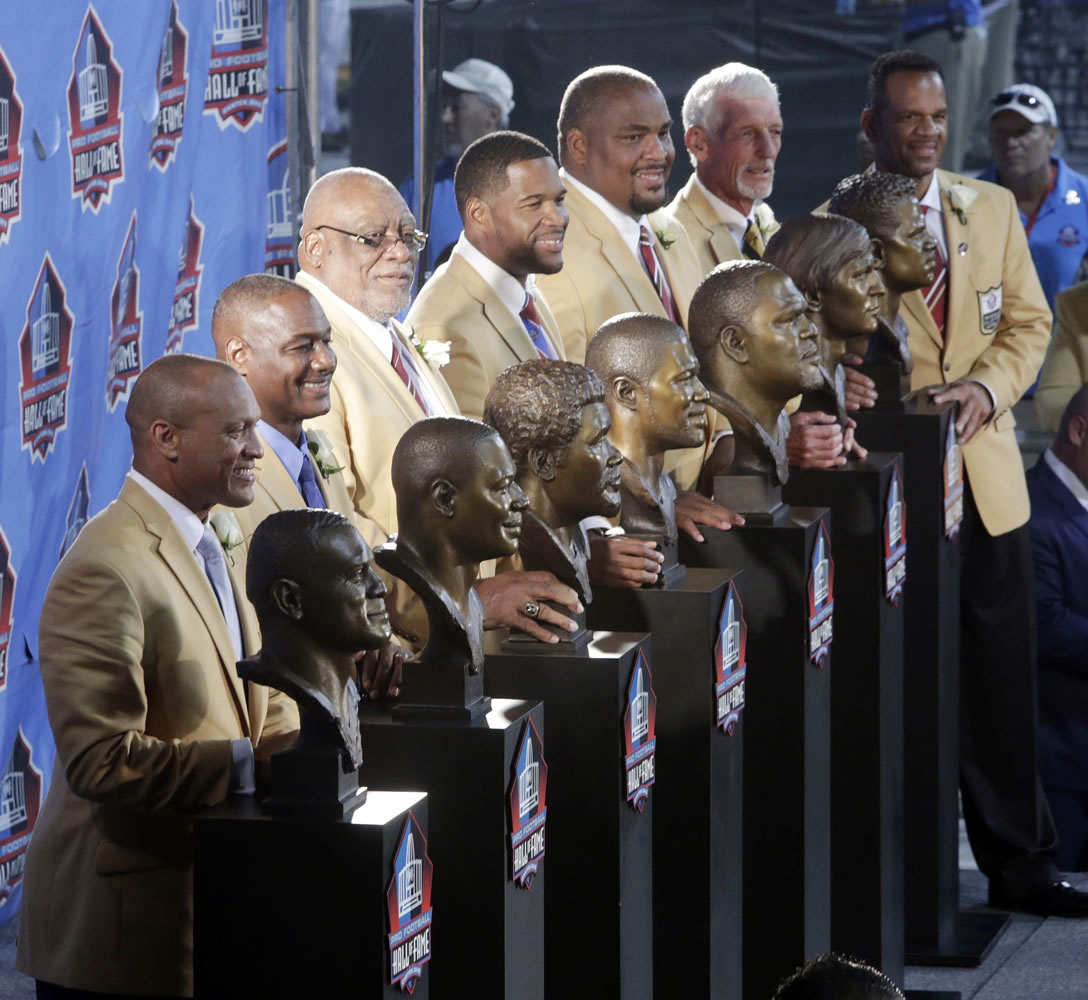 Hall of Fame Inductees Aeneas Williams, left to right, Derrick Brooks, Claude Humphrey, Michael Strahan, Walter Jones, Ray Guy, Andre Reed pose with their bustsduring the 2014 Pro Football Hall of Fame Enshrinement Ceremony at the Pro Football Hall of Fame Saturday, Aug. 2, 2014, in Canton, Ohio.