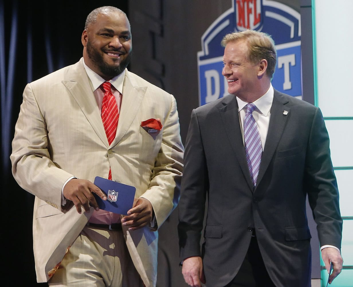 Walter Jones, left, walks with NFL Commissioner Roger Goodell after Jones announced a Seattle Seahawks'  pick at the 2014 NFL Draft in New York.