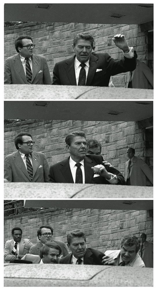 President Reagan waves, then looks up before being shoved into presidential limousine by Secret Service agents March 30, 1981, after being shot outside a hotel in Washington.