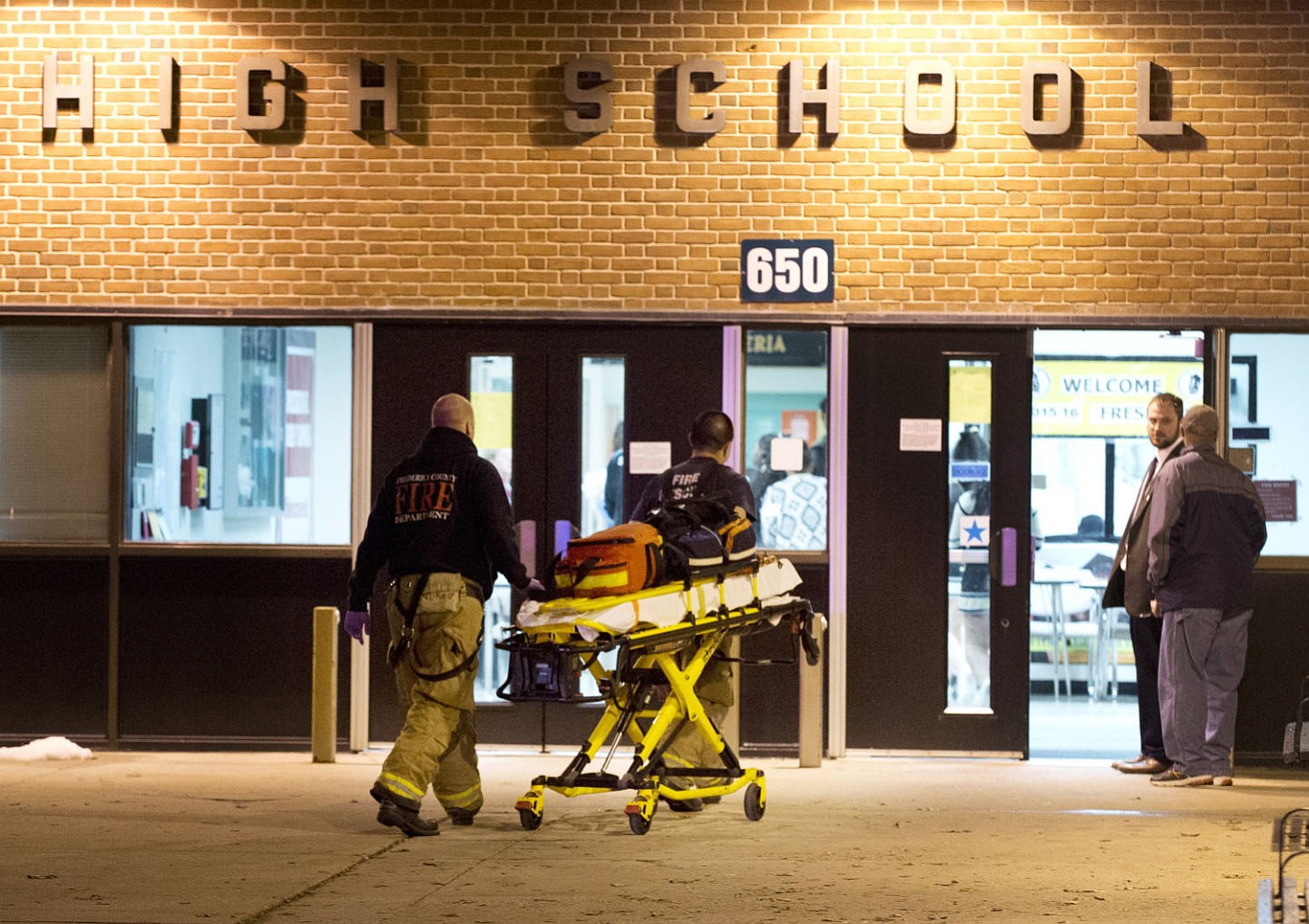 Bill Green/The Frederick News-Post
Officials enter Frederick High School on Wednesday in Frederick, Md. Police and school officials said students were shot outside the school while a basketball game was being played inside.